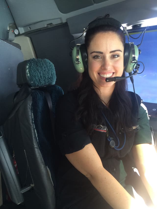 Chelsey in-flight in commercial airplane wearing pilot headset